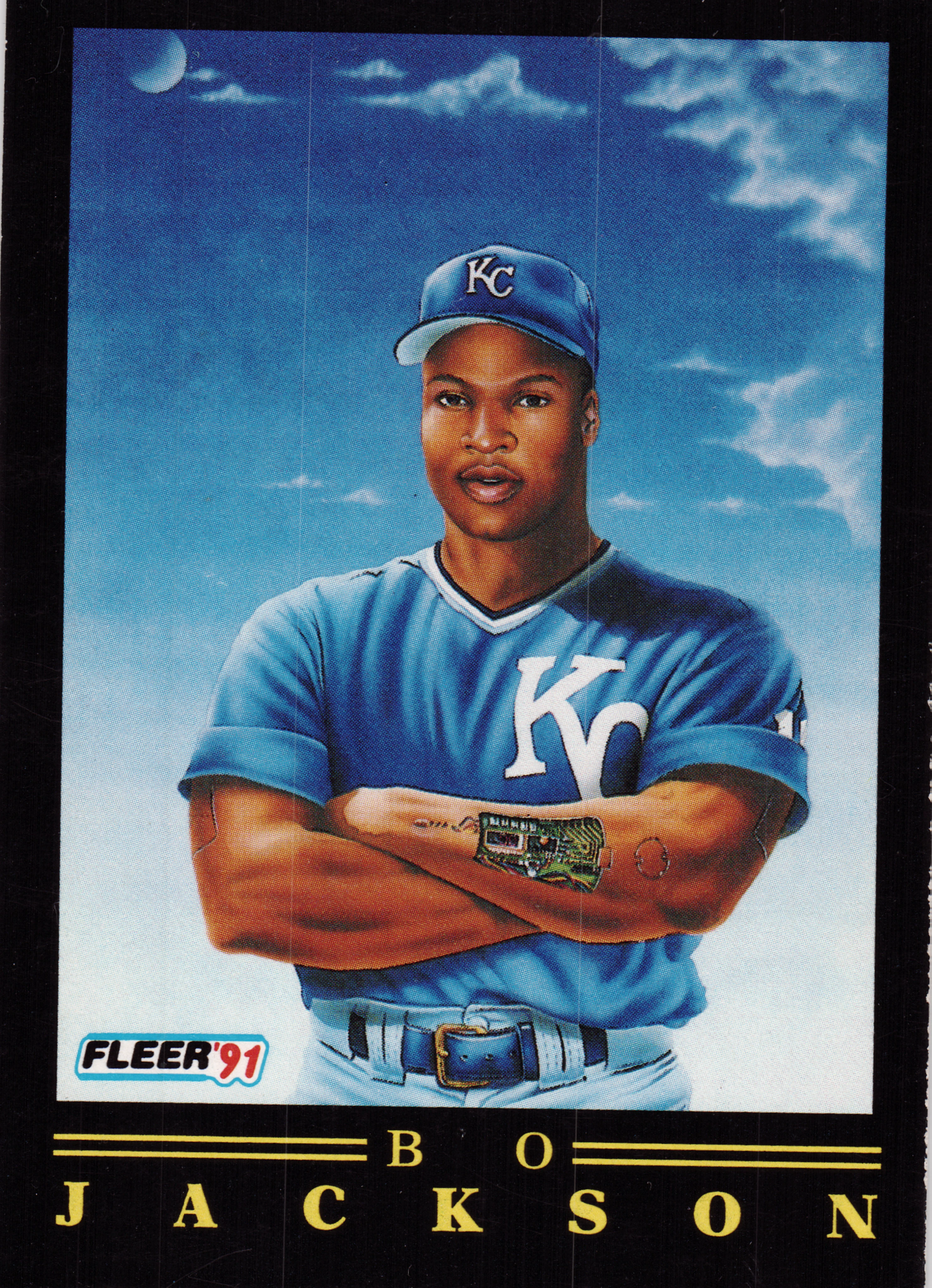 Front of 1991 Fleer Baseball Bo Jackson #5 OF 12 1991 Fleer Bo Jackson #5 OF 12, painted portrait of a player in a Kansas City Royals blue uniform and KC cap, arms crossed, against a blue sky with clouds and a moon; black border…