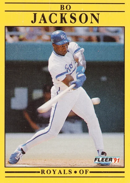 Front of 1991 Fleer Corp. Fleer Bo Jackson #561, yellow-bordered card with black rules. Player name 'BO JACKSON' printed at top in black serif capitals. Action photo of a batter in a white Kansas…