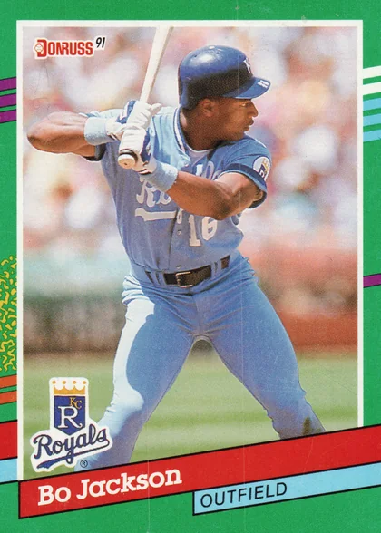 Front of 1991 Leaf, Inc. Bo Jackson #632, portrait-orientation card front with green border and diagonal multicolor stripes. Photo shows a batter in a light blue Royals uniform (#16)…
