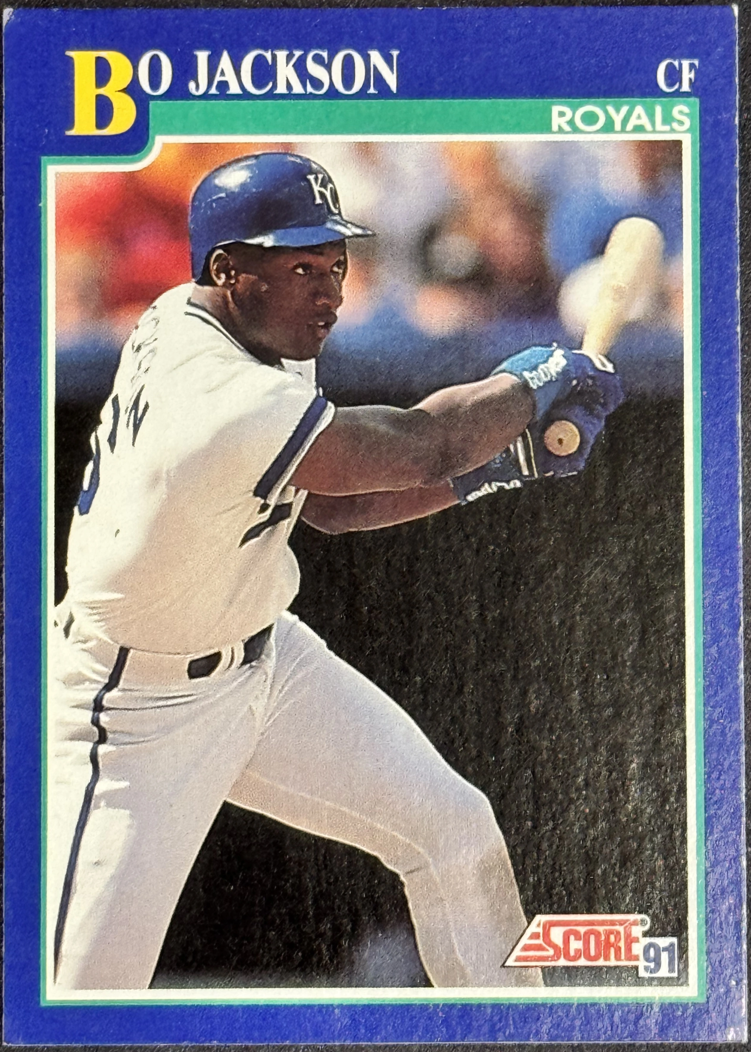 Front of 1991 Score Score 91 Derek Jeter #5, a baseball card front showing a player in a white New York Yankees uniform and a blue batting helmet with 'KC' on it, holding a bat in a batting…