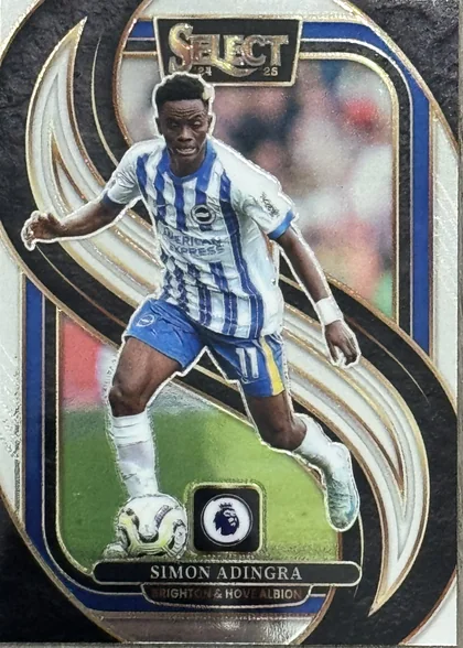 Front of 2024-25 Panini Select Premier League Soccer Simon Adingra #139 Mezzanine Prizm, a soccer trading card featuring a die-cut image of player Simon Adingra in a white and blue striped Brighton & Hove Albion jersey, number 11…